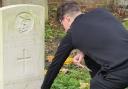 Student tends Commonwealth grave of First World War Royal Navy sailor in Dagenham churchyard who died aged 24