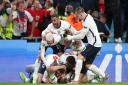 England's Harry Kane is mobbed by team-mates after scoring their side's second goal of the game in extra-time during the UEFA Euro 2020 semi final match at Wembley Stadium, London. Picture date: Wednesday July 7, 2021.