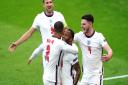 England's Raheem Sterling (centre) celebrates scoring their side's first goal of the game with Kyle Walker (left), Harry Kane and Declan Rice (right) during the UEFA Euro 2020 Group D match at Wembley Stadium, London. Picture date: Tuesday June 22, 2021.