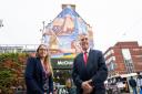 Simone Panayi and Cllr Darren Rodwell in front of a mural celebrating Barking's history which has been created by artist Jake Attewell.