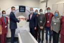 Flanked by hospital staff, Wes Streeting MP (left) and Sam Tarry MP (right) cut the ribbon on King George Hospital's new CT scanner