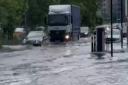 Vehicles navigate flooding near Gants Hill Roundabout on Sunday, July 25.