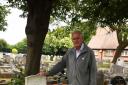 Dave Rose with the grave of a soldier who died aged 19 and whose name is not on any memorial in Barking and Dagenham