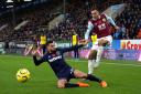 West Ham United's Ryan Fredericks (left) and Burnley's Dwight McNeil battle for the ball during the Premier League match at Turf Moor, Burnley.