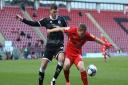 Leyton Orient striker Danny Johnson holds off Crawley Town's Jordan Tunnicliffe