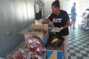 A volunteer puts together a food parcel in Colombia. Picture: Stand By Me