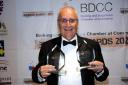Farley Shelkin proudly holds the two awards won by his business Dagenham Travel