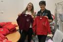Charity worker Marie Quaife (left) helps school uniform sale with hospital's Charleen Elton