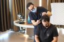 Dr. Levant Acar performing a hair analysis at the Cosmedica Clinic