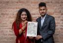 Same-sex couple Surendra Pandey, right, and Maya Gurung pose for a photograph with their marriage certificate (Niranjan Shrestha/AP)