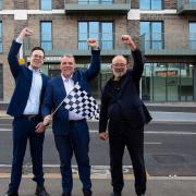 Darren Rodwell waves the chequered flag on the Chequers Lane scheme with Michael Westbrook (left) and Kevin Parsons (right)