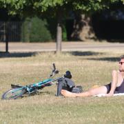 A man sunbathes this morning (July 11) in Kensington Gardens, south London, as Britons are set to sizzle on what could be the hottest day of the year so far
