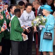 Queen Elizabeth II speaks with pupils during a tour of Sydney Russell School in Dagenham, east London, in 2015.