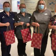 Staff with the gift bags full of treats for children in hospital
