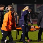 Medical staff and stewards carry Upminster man Kevin Roome away on a stretcher during the FA Cup first round match between Dagenham & Redbridge and Salford City.