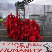 Members of the Red Rebel Brigade outside the Scottish Events Campus stage a  protest outside the COP26 summit