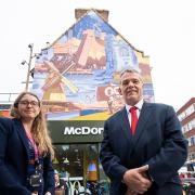 Simone Panayi and Cllr Darren Rodwell in front of a mural celebrating Barking's history which has been created by artist Jake Attewell.