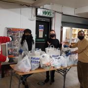 Leader of the council, Cllr Darren Rodwell, with Youth League UK programme manager John Wainaina and volunteers pack food and essentials.
