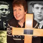 Kim Smith (centre) holding the cross she will erect. Her three great-uncles (Clockwise from top left) John, Francis and Albert.