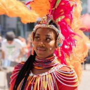 A performer in colourful carnival dress in 2022