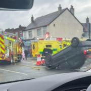 Emergency services at the scene of the overturned car