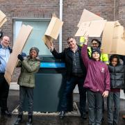 Waving their cardboard waste ready to shred at Barking Riverside