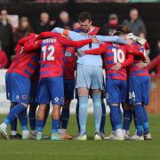 Dagenham & Redbridge players huddle before kick-off at Victoria