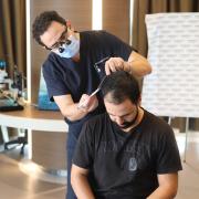 Dr. Levant Acar performing a hair analysis at the Cosmedica Clinic