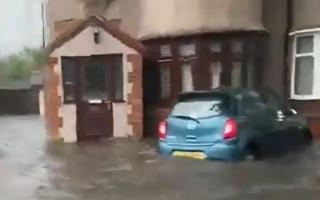 An image of a car partially submerged as flooding hits Havering and Dagenham during a storm that saw a 