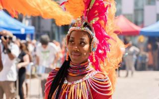 A performer in colourful carnival dress in 2022